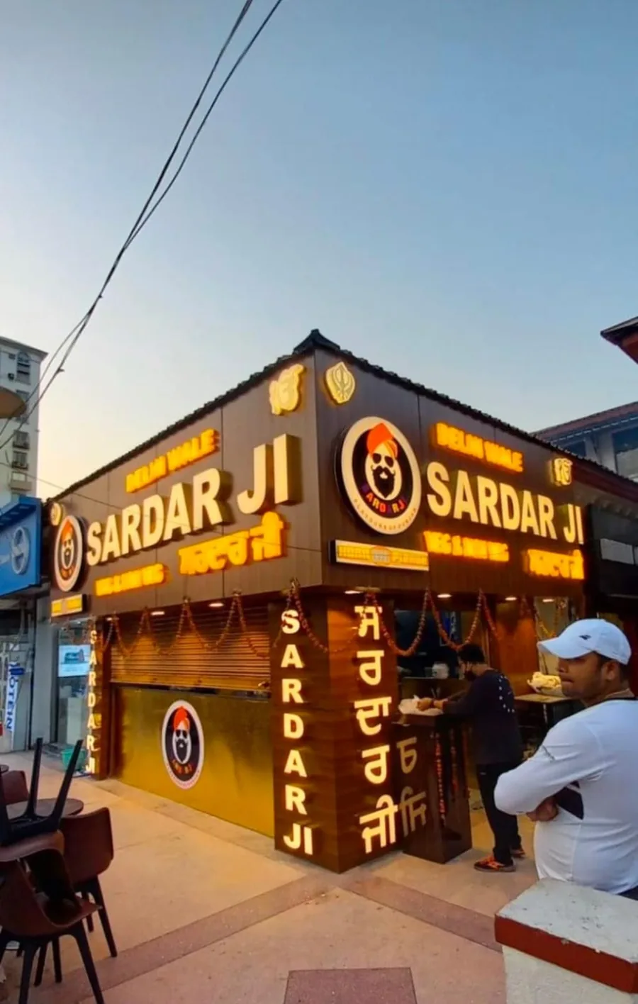 Shop front with glowing 3D sign board and branding in the evening